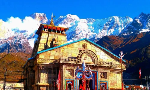 Temple against snowy mountain backdrop